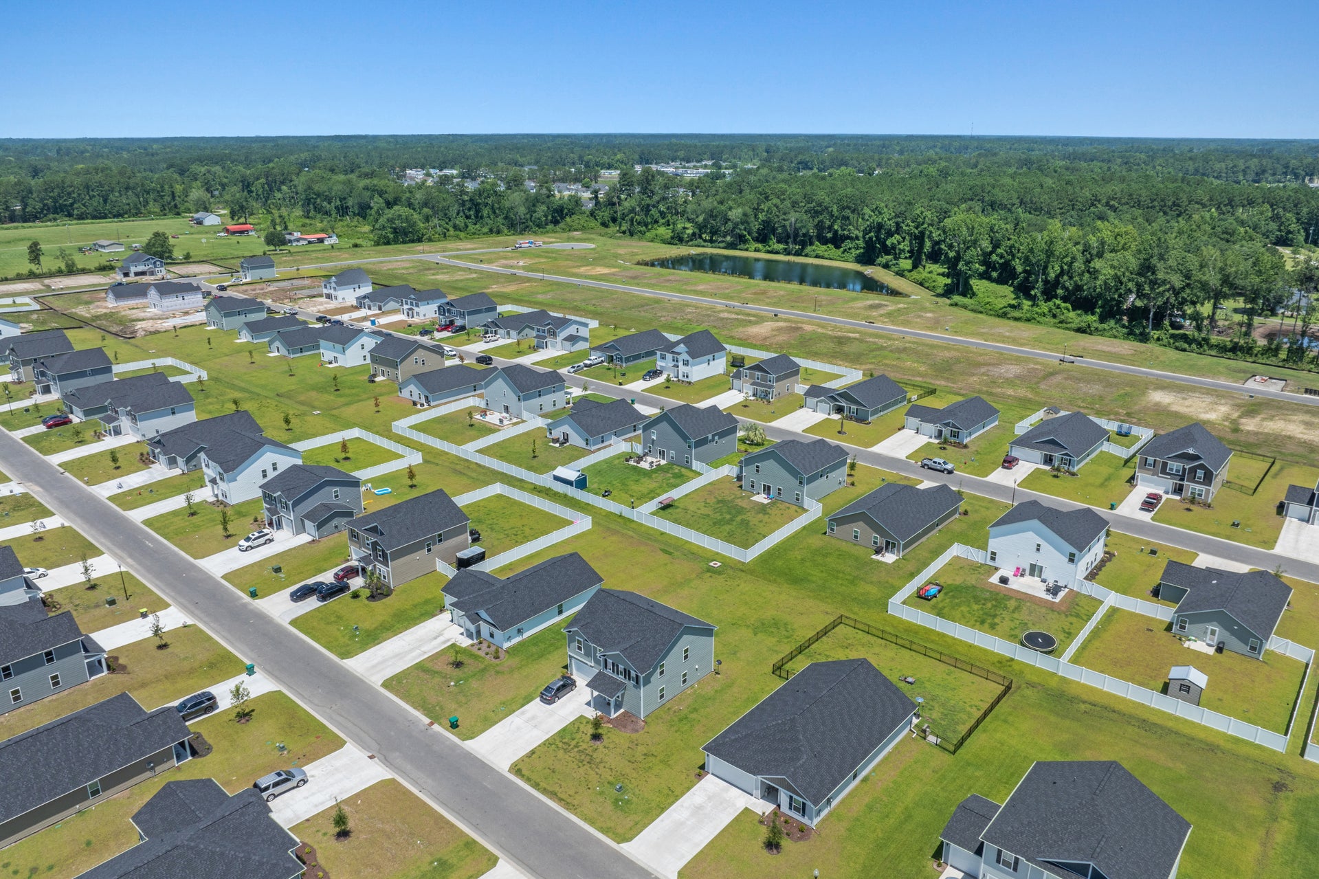 Aerial view of a modern Southeast suburban development meeting open land