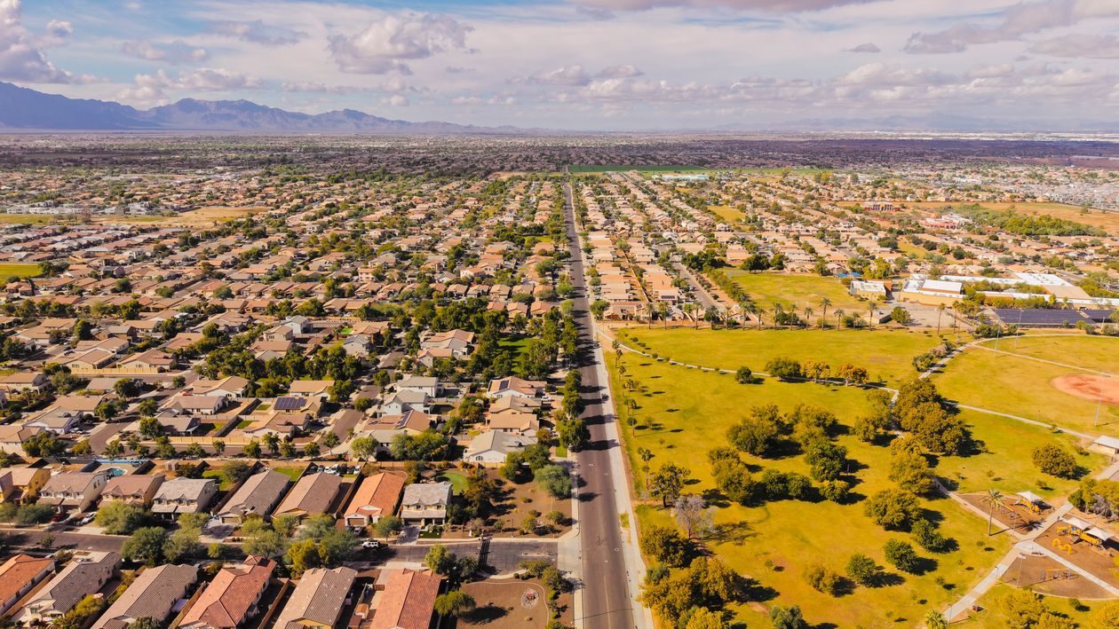 Aerial view of suburban expansion meeting open developable land
